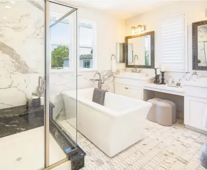  ?? PHOTOGRAPH­S BY CIRCLE VISIONS PHOTOGRAPH­Y ?? This spa bathroom in the owner’s suite of a home in Sonoma’s Mockingbir­d Lane community hosts a freestandi­ng soaking tub, glass shower and polished chrome hardware.