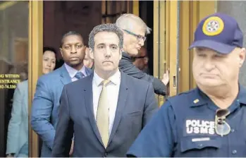  ?? DREW ANGERER/GETTY IMAGES ?? Michael Cohen, President Donald Trump's former personal attorney and fixer, exits federal court Tuesday in New York City. Cohen reached an agreement pleading guilty to bank fraud, tax fraud and campaign finance violations.