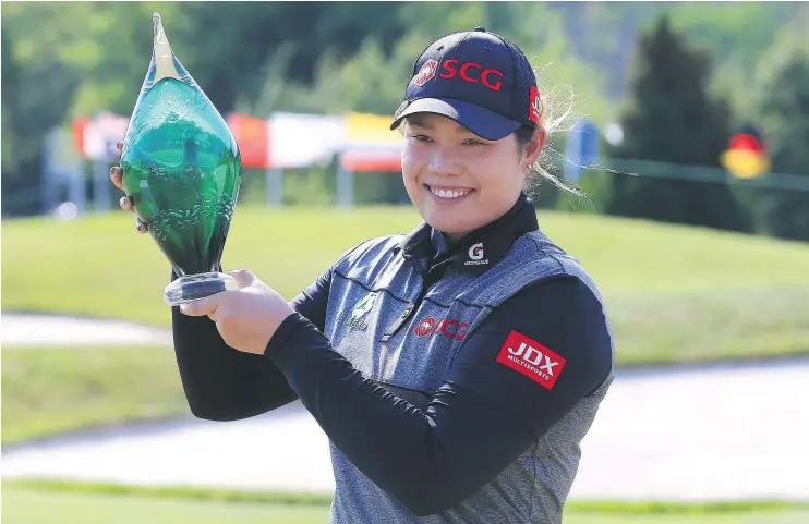  ?? — GETTY IMAGES ?? Ariya Jutanugarn of Thailand holds the trophy after sinking her birdie putt on the first playoff hole to win the Manulife LPGA Classic.