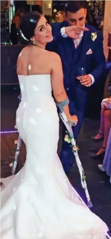  ??  ?? Brave bride: Emily Patel with flower-clad crutches