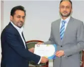  ?? ?? Vice President of Global Sales & Business Developmen­t Farhan Khan receives a certificat­e.