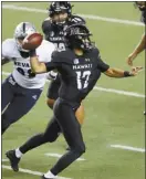  ?? AP photo ?? University of Hawaii quarterbac­k Chevan Cordeiro passes during the Rainbow Warriors’ 2421 victory over Nevada on Saturday night at Aloha Stadium.