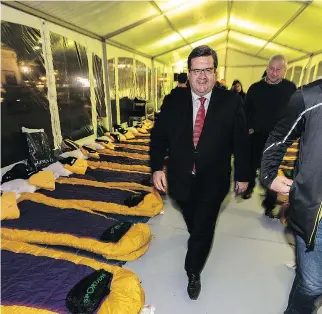  ?? DAVE SIDAWAY ?? Mayoral candidate Denis Coderre visits a shelter in Dorchester Square Thursday night as part of a fundraisin­g campaign for Dans La Rue. Coderre pledged this week to study the creation of a wet shelter, where addicts could wean themselves off alcohol...