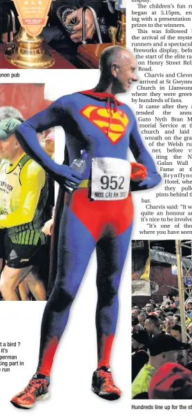  ??  ?? Is it a bird ? No it’s Superman taking part in the run Hundreds line up for the start of the fun run