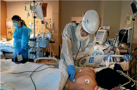  ?? AP ?? Dr Rafik Abdou checks on a Covid-19 patient at Providence Holy Cross Medical Centre in the Mission Hills section of Los Angeles.