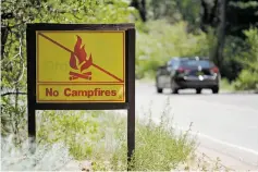  ??  ?? A ‘no campfires sign’ Tuesday in Hyde Park. A combinatio­n of warm temperatur­es, low humidity and growing winds may produce a combustibl­e mix, and it’s likely to remain that way for up to two weeks.