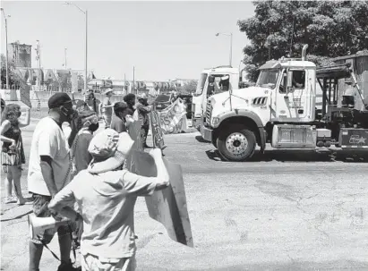  ?? KIM HAIRSTON/BALTIMORE SUN ?? Protesters line the entrance to the facility preventing trucks from entering and exiting Wednesday as the SB7 Coalition Inc. holds a rally to shut down the BRESCO trash incinerato­r and advocate for building a zero waste infrastruc­ture.