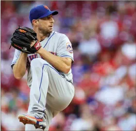  ?? AARON DOSTER — THE ASSOCIATED PRESS FILE ?? New York Mets’ Max Scherzer throws during a baseball game against the Cincinnati Reds in Cincinnati on July 5, 2022. The three-time Cy Young Winner says the biggest benefit of the change is that all of Major League Baseball is under one set of rules.