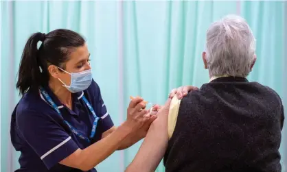  ?? Photograph: Joe Giddens/EPA ?? A patient receives a Covid-19 vaccine at Robertson House in Stevenage, Hertfordsh­ire.