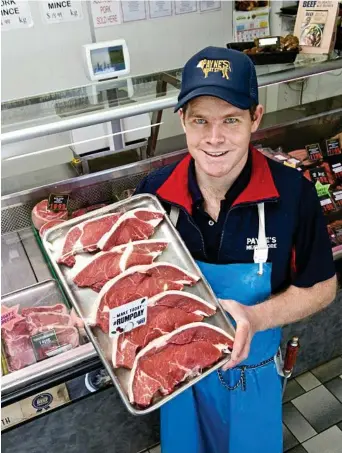  ??  ?? HAPPY BUTCHER: Aaron Vietheer loves his job as manager at Payne’s Meat Store in Toowoomba. PHOTO: NEV MADSEN