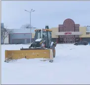  ?? MITCH HOTTS — THE MACOMB DAILY ?? A snowplow operator removes snow from the parking lot of AMC Star Gratiot 15 Theater on Gratiot Avenue in Clinton Township on Monday afternoon. The National Weather Service issued a winter storm warning for the region that started at 6p.m. Monday and expires at noon today.