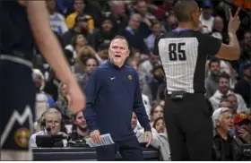  ?? AARON ONTIVEROZ — THE DENVER POST ?? Denver Nuggets head coach Michael Malone questions a foul call on Zeke Nnaji by referee Robert Hussey during the first quarter against the Utah Jazz at Ball Arena in Denver on Monday.