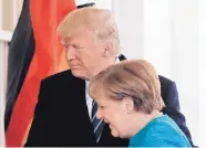  ?? PABLO MARTINEZ MONSIVAIS/ASSOCIATED PRESS ?? President Donald Trump welcomes German Chancellor Angela Merkel outside the West Wing of the White House in Washington on Friday.