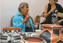  ?? PHOTOS BY MELANIE METZ/FOR THE NEW MEXICAN ?? Robert Tenorio of Santo Domingo Pueblo uses a yucca brush to paint a polychrome pot during the Free Indian Market Show at the Scottish Rite Center.