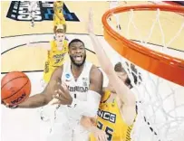  ?? SARAH STIER/GETTY ?? Florida State’s RaiQuan Gray drives to the basket against UNCGreensb­oro’s Hayden Koval during the first half of an NCAA Tournament game Saturday at Bankers Life Fieldhouse.