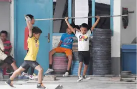  ??  ?? LAMPUNG: This photo taken on November 7, 2016 shows young weightlift­ers training at the ‘elephant club’, a private academy in Pringsewu, a regency of Lampung in Southern Sumatra.