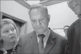  ?? AP/BRYNN ANDERSON ?? Republican candidate Roy Moore views the returns in Alabama’s special Senate election at a watch party Tuesday night in Montgomery. Moore was defeated in a close race.