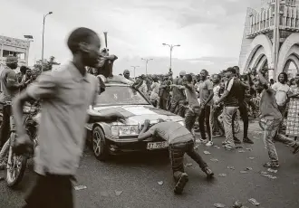  ?? Associated Press ?? People celebrate in the streets Tuesday in Bamako, the capital of Mali. Troops detained Mali’s leaders after months of demonstrat­ions calling for President Ibrahim Boubacar Keita’s ouster.