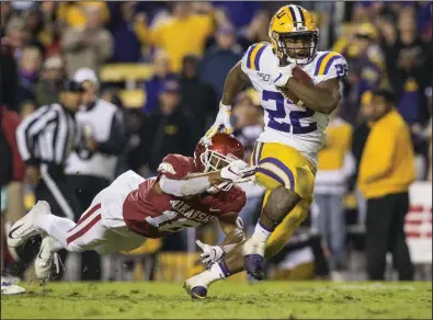  ?? (NWA Democrat-Gazette file photo) ?? LSU running back Clyde Edwards-Helaire breaks the tackle of Arkansas strong safety Myles Mason on his way to a touchdown during their matchup last November. Both teams find themselves in different situations a year later as they prepare to meet Saturday in Fayettevil­le.