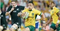  ?? AP file ?? Australia’s Christian Leali’ifano (centre) runs away from New Zealand’s Richie McCaw (left) during the Bledisloe Cup. —