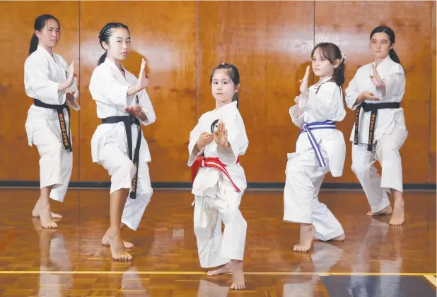  ?? Picture: BRENDAN RADKE ?? STRIKE A POSE: Fudoshin Shitoryu Karate classes have begun again at Cairns State High School, after a strict COVID Safe plan was implemente­d. Students include Mikoto Nomura, 16, Cocona Sakamoto, 15, Kairi Scott, 7, Saya Jinno, 10, and Katelyn Row, 16.