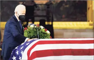  ?? Mariam Zuhaib / Associated Press ?? President Joe Biden touches the flag-draped casket of former Senate Majority Leader Harry Reid of Nevada, as he lies in state in the U. S. Capitol Rotunda on Wednesday.