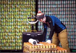  ?? RENÉE JONES SCHNEIDER/MINNEAPOLI­S STAR TRIBUNE/TNS ?? Packing manager Erik Raivo packages up beer for distributi­on at Indeed Brewing Company on Friday, Feb. 18, 2022, in Minneapoli­s, Minnesota.