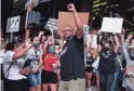  ?? SEAN LOGAN/THE REPUBLIC ?? Jacob Raiford holds up his fist while marching in Phoenix on Saturday, the 57th anniversar­y of the historic March on Washington.