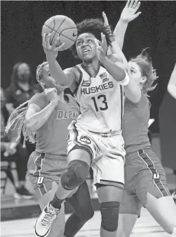  ?? CHARLES REX ARBOGAST/AP ?? UConn’s Christyn Williams scores past DePaul’s Deja Church, left, and Evina Westbrook on Sunday in Chicago.