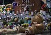  ?? JAE C. HONG — THE ASSOCIATED PRESS ?? A large stuffed bear is placed at a memorial in front of crosses bearing the names of the victims killed in last week's school shooting in Uvalde, Texas, on Saturday.