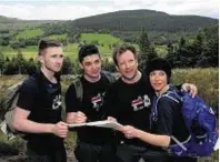  ??  ?? The KPMG team map reading during the challenge