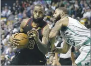 ?? MICHAEL DWYER — THE ASSOCIATED PRESS ?? Cleveland’s LeBron James, left, drives past the Celtics’ Marcus Morris during the third quarter Sunday in Boston.