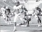  ??  ?? Tiger tailback Brandon Hayes scores the first of his three touchdowns on Saturday. He also topped 100 yards in rushing.