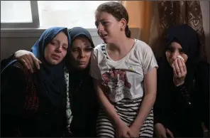  ?? AP/KHALIL HAMRA ?? Relatives of 15-year-old Ameer al-Nimra, who was killed along with another teenager on Saturday in an Israeli airstrike on Gaza, mourn during his funeral in the family home Sunday in Gaza City.