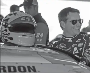  ??  ?? KID STUFF: Jeff Gordon prepares to get in his car before practice Friday at Homestead-Miami Speedway, where competes today in his final race with a chance to win his fifth series title.