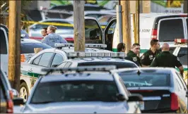  ?? LANNIS WATERS / THE PALM BEACH POST ?? Crime scene investigat­ors gather evidence on May 12, 2017, after an armed robbery of Duggan’s Pub &amp; Grill in suburban West Palm Beach.