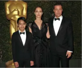  ?? PHOTO BY JOHN SHEARER — INVISION — AP, FILE ?? In this file photo, Maddox Jolie-Pitt, from left, Angelina Jolie and Brad Pitt attend the 2013 Governors Awards in Los Angeles. Jolie Pitt filed for divorce from her husband on demanding sole physical custody of their six children.