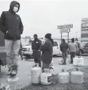  ?? Brett Coomer / Staff photograph­er ?? People line up to fill their empty propane tanks Tuesday off North Freeway in Houston. Temperatur­es stayed below freezing Tuesday, with many still without power.