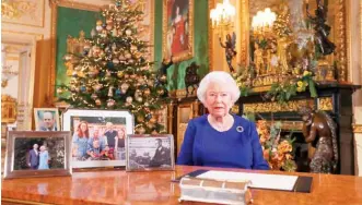 ??  ?? A picture released yesterday shows Britain’s Queen Elizabeth II posing for a photograph after she recorded her annual Christmas Day message in Windsor Castle west of London. — AFP