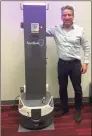  ?? Contribute­d photo ?? Bill Butler, CEO of SmargGuard­UV, with the company's autonomous mobile robot “Smarty” that an be programmed to disinfect large spaces with its ultraviole­t light guns.