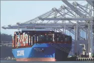  ?? Ben Margot / Associated Press ?? A container ship waits to be unloaded at the Port of Oakland in Oakland, Calif. The Commerce Department said Wednesday that the trade deficit rose in January, up 5 percent from December.