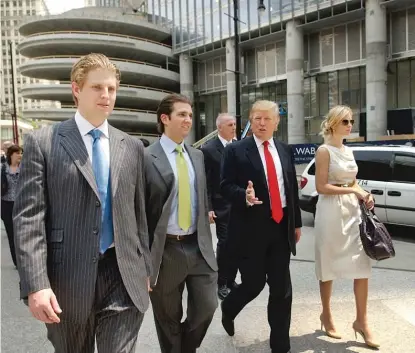  ??  ?? From left: Eric Trump, Donald Trump Jr., Donald Trump and Ivanka Trump walk past the Trump Hotel & Tower in Chicago in May 2007.