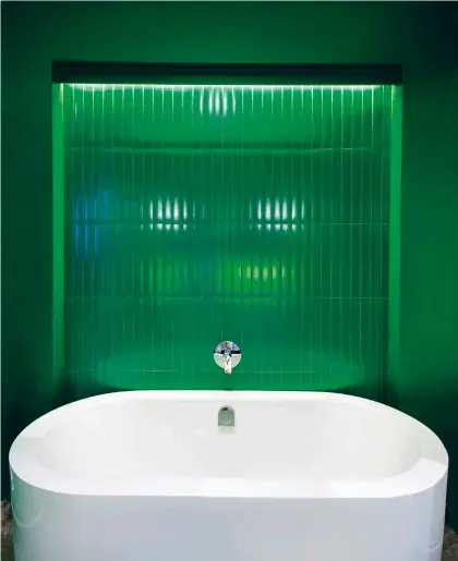  ??  ?? The Green Room bathroom features a vibrant shot of colour by way of vivid emerald green.
The tiles are from Tilespace and the mirrors were custom designed by Tonic to stand apart from the norm.
The generous bath is from Bella Bathrooms.