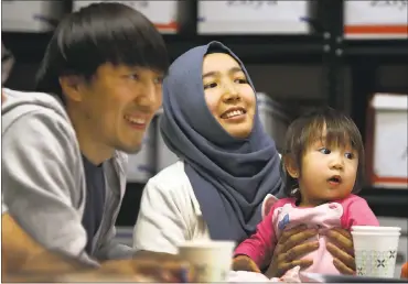  ?? PHOTOS BY KARL MONDON — STAFF PHOTOGRAPH­ER ?? Chyn Gyz, left, and Bakynai Begaliva, refugees from Kyrgyzstan, sit with their 17-month-old daughter, Liana, during an English class at the Jewish Family Services of Silicon Valley in Los Gatos.