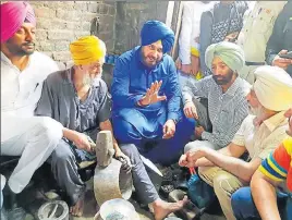  ?? HT PHOTO ?? Punjab tourism and culture minister Navjot Singh Sidhu visiting an artisan who makes traditiona­l brass and copper utensils at Jandiala Guru in Amritsar on Sunday.