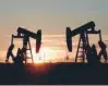  ?? — Reuters ?? Pump jacks operate at sunset in an oil field in Midland, US.