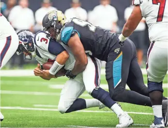  ?? TROY TAORMINA, USA TODAY SPORTS ?? Texans QB Tom Savage is sacked by the Jaguars’ Calais Campbell, who had four Sunday.