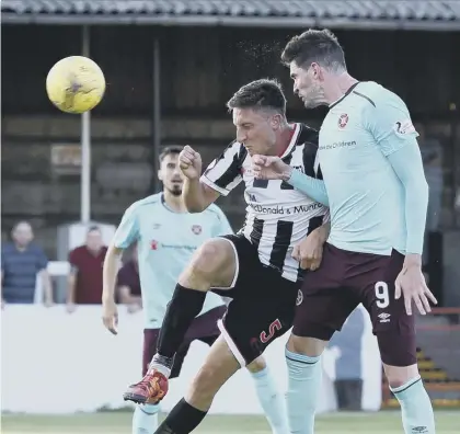  ??  ?? 2 Kyle Lafferty, on his debut for Hearts, heads home the Tynecastle club’s winner in the 60th minute at Borough Briggs last night. The goal allowed Hearts to play out the match in relative comfort. Inset below, Hearts boss Ian Cathro.