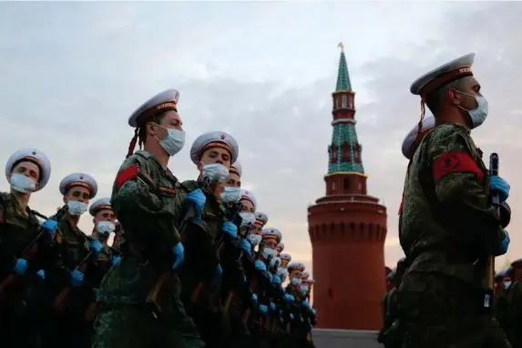  ?? (Sergei Bobylev/TASS) ?? Service personnel march in formation in Vasilyevsk­y Spusk Square as part of a rehearsal ahead of Wednesday’s military parade