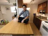  ?? AARON HARRIS FOR THE TORONTO STAR ?? Andy Tran shows off his renovated basement. Tran is a proponent of intensifyi­ng existing housing.